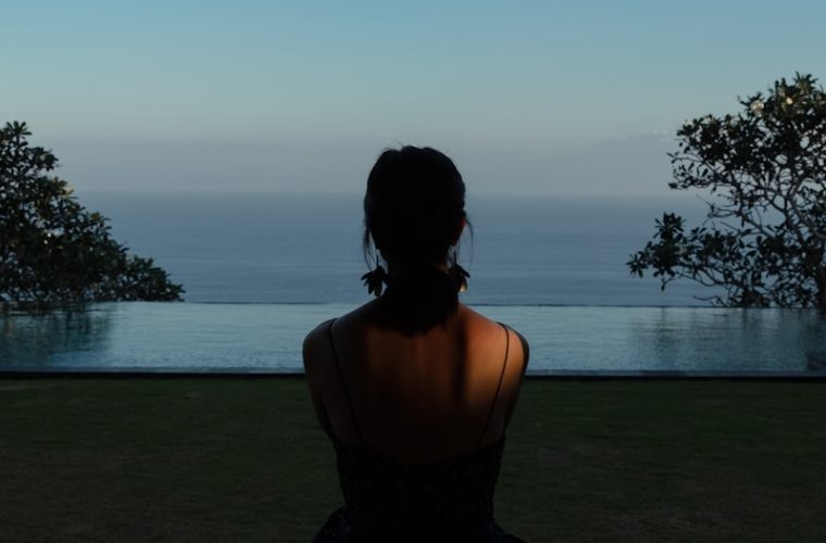 woman sitting on field during daytime